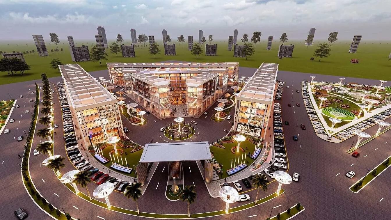 Artist's impression of Takmeel Square, a multi-storey commercial building with a tower beside a landscaped road in DHA Bahawalpur.
